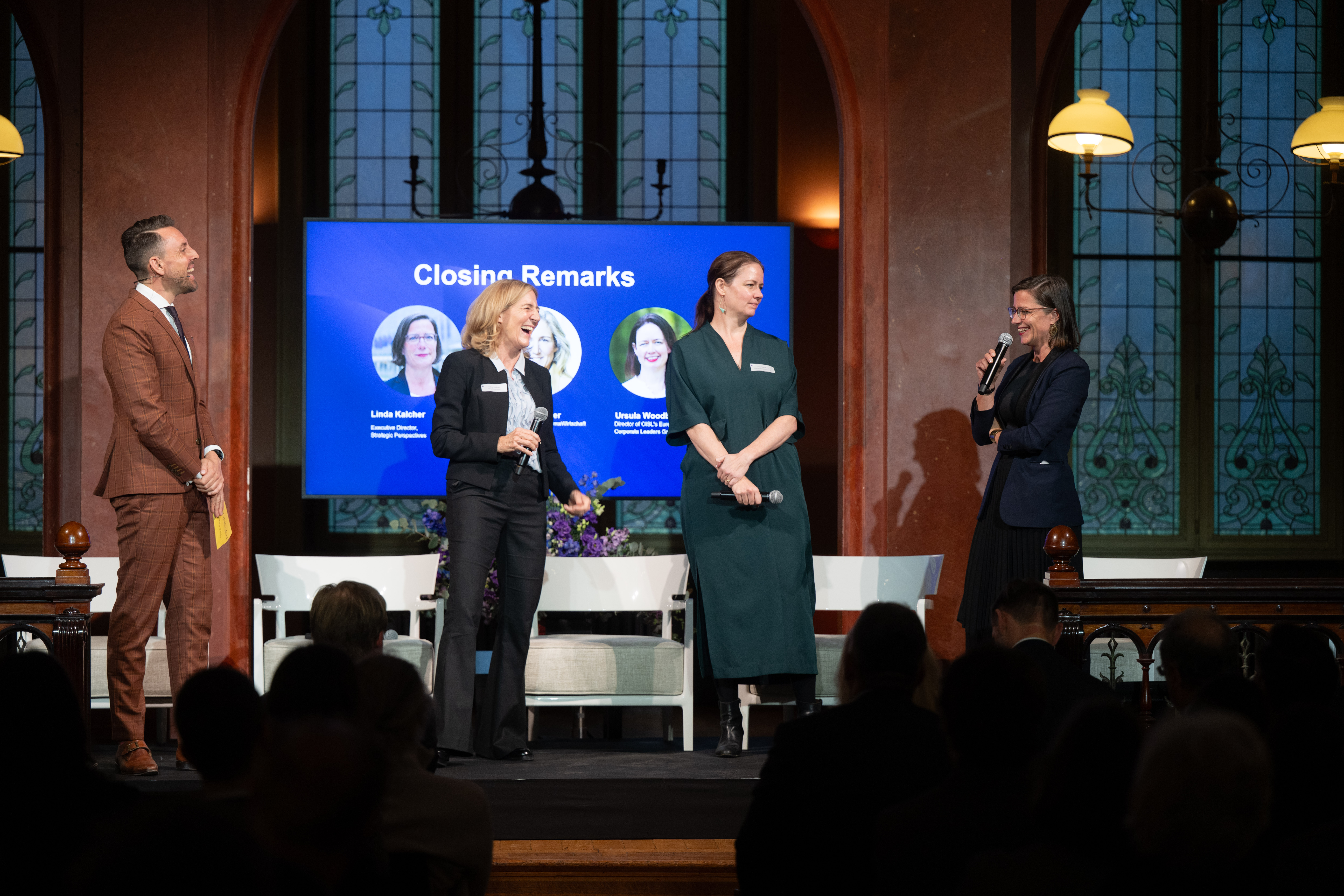 Speakers on stage during closing remarks at a policy event